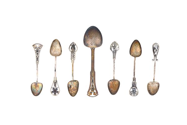 Six Art Nouveau coffee spoons, having differing decoration to the handles and a similar preserve spoon, detailed St. Silver and with a thistle mark, c