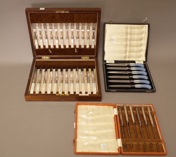 A set of twelve plated pairs of dessert or fruit knives and forks, having mother of pearl handles, by Walker & Hall, with a fitted case, a set of six