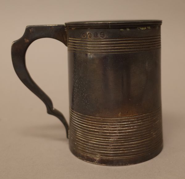 A George III silver christening mug, of tapered cylidrical form, decorated with reeded bands, London 1806, height 8.3cm, weight 158 gms.