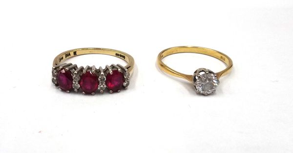 A 9ct gold, synthetic ruby and diamond ring, claw set with three oval cut synthetic rubies, alternating with four pairs of circular cut diamonds, ring