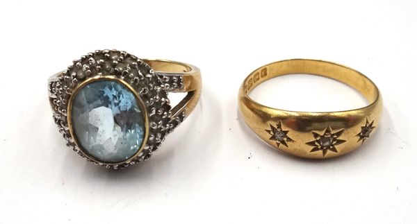 A 9ct gold, blue topaz and diamond set oval cluster ring, with diamond set split shoulders, ring size P and an 18ct gold ring, star gypsy set with thr