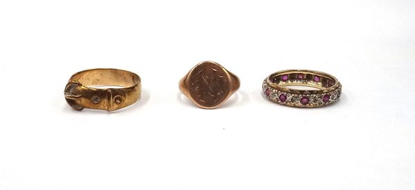 A 9ct gold ring, in a buckle and strap design, a gold oval signet ring, detailed 9 CT and a 9ct gold, diamond and ruby set full eternity ring, ring si