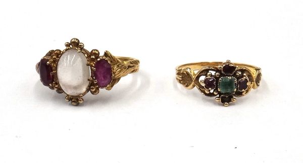 A gold, moonstone and garnet set three stone ring, mounted with the oval moonstone to the centre, between two oval cut garnets, ring size L and a half