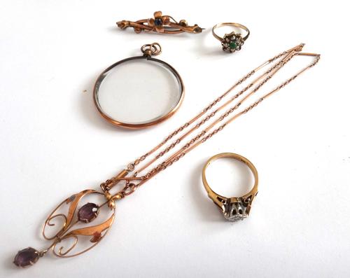 A gold and amethyst pendant, in an openwork design, mounted with two oval cut amethysts, detailed 9 CT, with a gold bar and oval link neckchain, on a