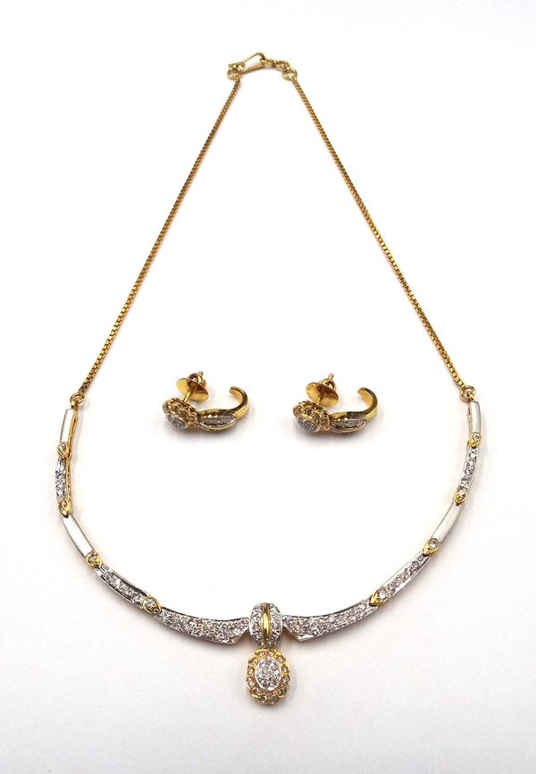 A gold and diamond set necklace, the front with a diamond set oval cluster drop, between tapering diamond set sides, mounted with circular cut diamond