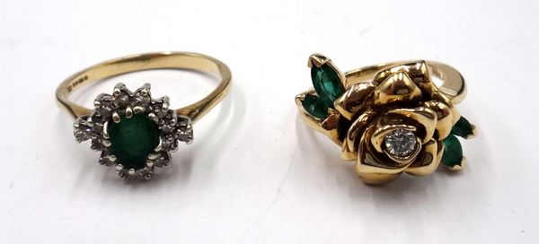 A 14ct gold, emerald and diamond ring, designed as a floral spray, mounted with a circular cut diamond to the flowerhead centre and further set with f