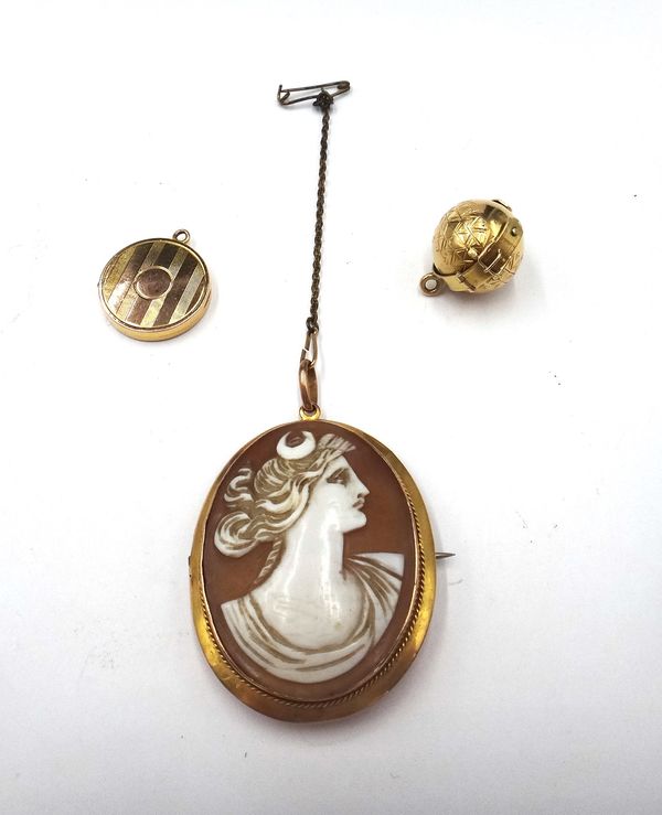 A Victorian spherical gold cased folding pendant locket, opening to reveal four compartments, the exterior with two folding strap motifs, otherwise wi