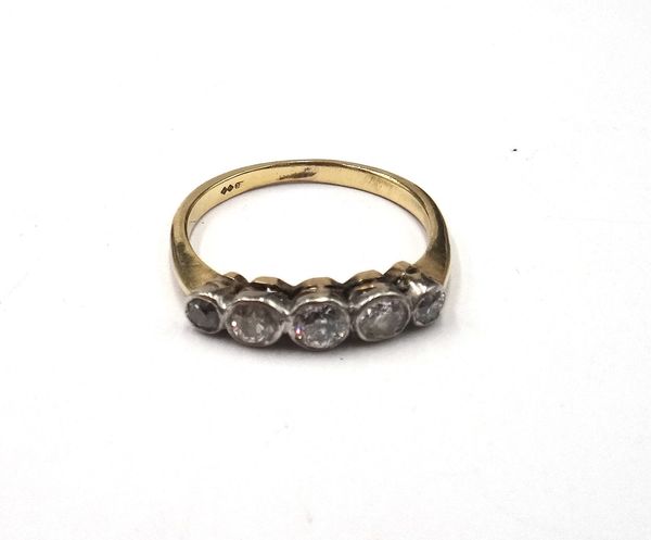 A gold and diamond five stone ring, collet set with a row of cushion shaped diamonds graduating in size to the centre stone, ring size R and a half.