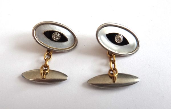 A pair of diamond set, black onyx and mother of pearl dress cufflinks, with gem set oval fronts and with plain torpedo shaped backs, gross weight 6.3