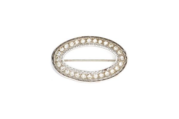 A diamond set brooch, of oval openwork form, mounted with circular cut diamonds, between lattice work pierced sides, length 3.5cm. Illustrated.