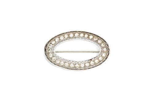 A diamond set brooch, of oval openwork form, mounted with circular cut diamonds, between lattice work pierced sides, length 3.5cm. Illustrated.