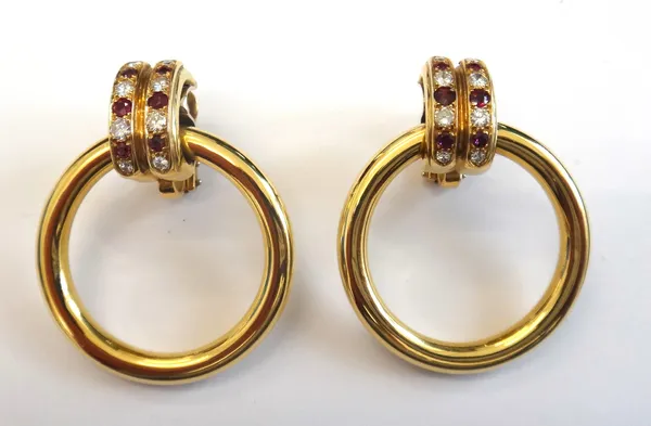 A pair of gold, ruby and diamond set hoop shaped earrings, each top mounted with two rows of alternating circular cut rubies and diamonds supporting a