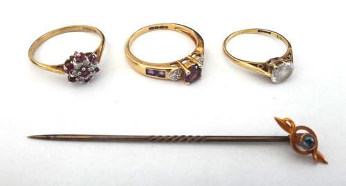 A 9ct gold, amethyst and diamond ring, claw set with the principle circular cut amethyst to the centre, between diamond set heart shaped shoulders, a