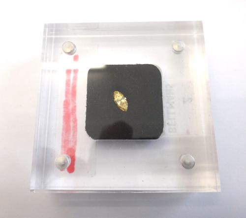A marquise-cut loose diamond, 0.36ct, fancy intense orangy yellow, SI1, in magnetic perspex case, boxed.This Lot is subject to VAT on the hammer.