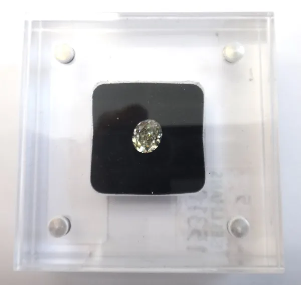 An oval-mixed-cut loose diamond, 1.11ct, colour S/Z range, clarity SI2/I1, magnetic perspex case, boxed.This Lot is subject to VAT on the hammer.