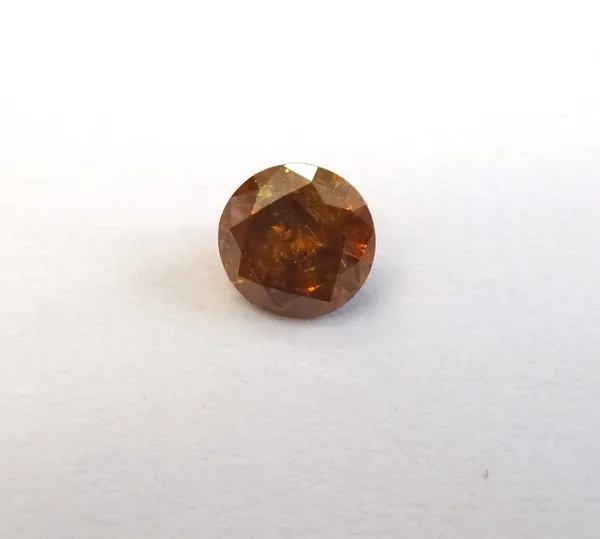 A round brilliant-cut diamond, 0.58ct., deep yellowish orange, pique.  This Lot is subject to VAT on the hammer.