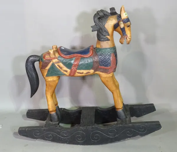 A 20th century child's hardwood rocking horse with painted decoration.   F8