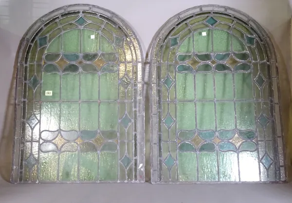 A pair of early 20th century arch top stained glass windows, (2).   CAB