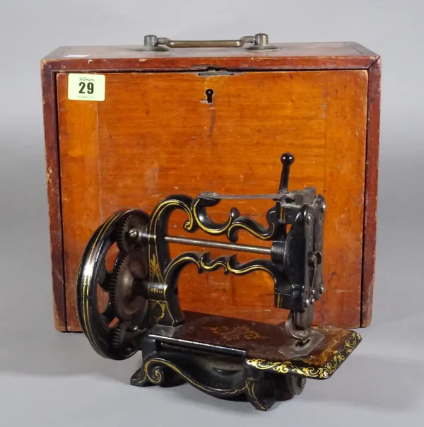 A mahogany cased miniature sewing machine.  CAB