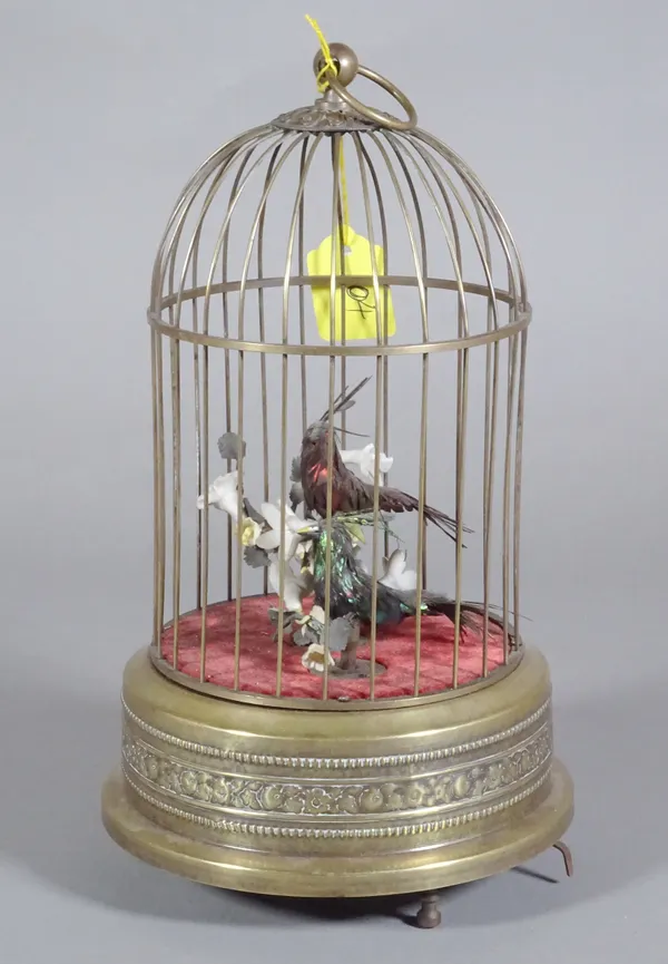 A brass cased musical bird cage. 36cm tall.  CAB