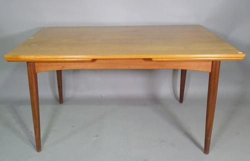 A 20th century teak drop end extending table on tapering supports, 135cm wide x 73cm high  x 235cm fully extended, a set of four G-Plan stick dining c