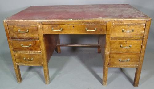A 20th century mahogany pedestal desk with six short and one long drawer about the knee and faux red leather top 136cm wide x 76cm high.  H5