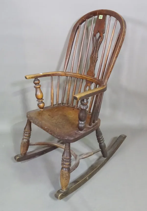 A 19th century ash and elm stick back rocking open armchair on ring turned tapering supports.   D8