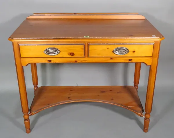 A 20th century pine dressing table with two drawers over platform undertier on tapering supports, 97cm wide x 81cm high.   F10