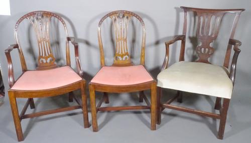 A set of six George III mahogany arch top dining chairs, to include two carvers and a George III mahogany open armchair, (7).   D8