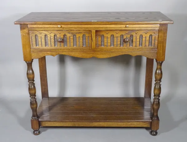 An 18th century style oak two drawer side table on turned supports, 100cm wide x 86cm high.   I9
