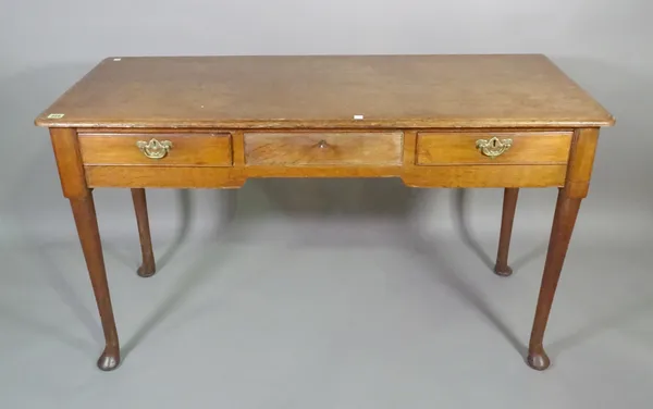 A 19th century oak side table with three frieze drawers and pad feet, 127cm long.  G10