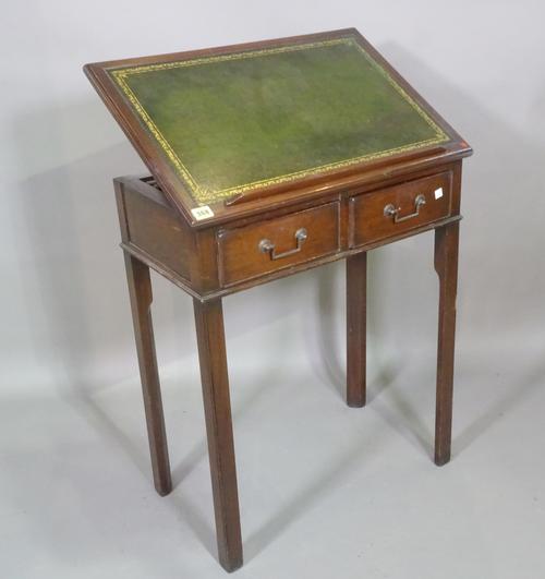 A 20th century mahogany two drawer adjustable reading table with green leather inset top on block supports, 64cm wide x 80cm high.   C6