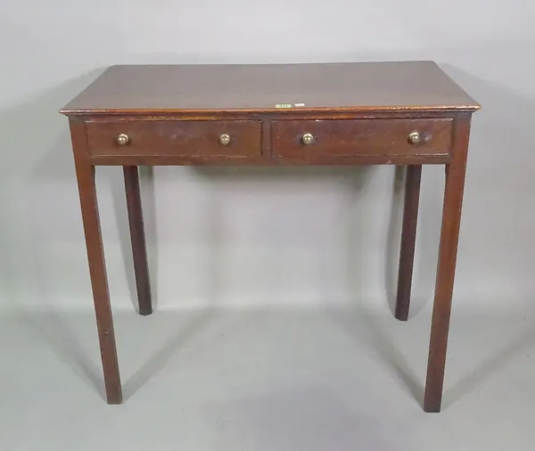 A 19th century two drawer writing table on block supports, 86cm wide x 76cm high.   G9