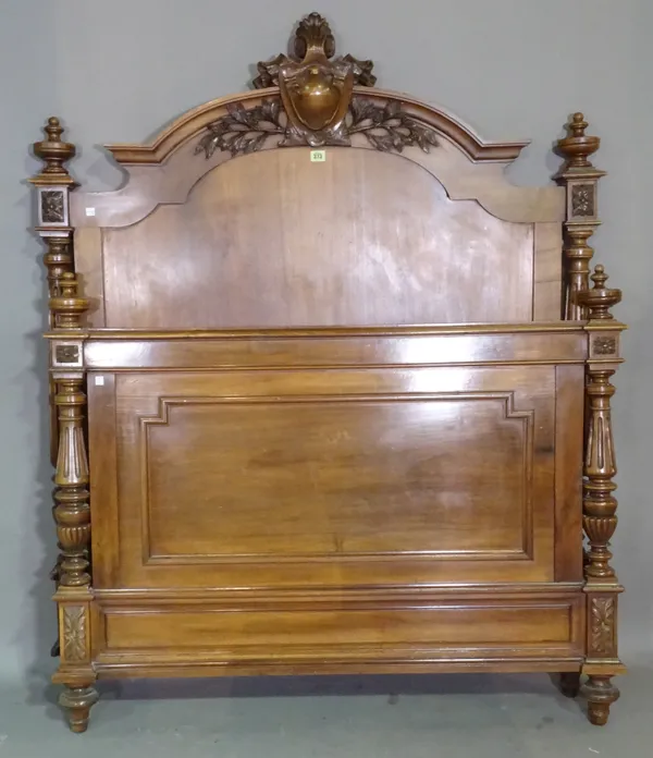 A 19th century French mahogany carved bed with acanthus shield headboard and fluted turned column supports.   H10