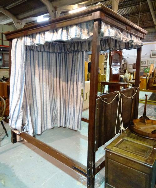 A George III and later mahogany four poster bed on reeded twisted supports.   H8