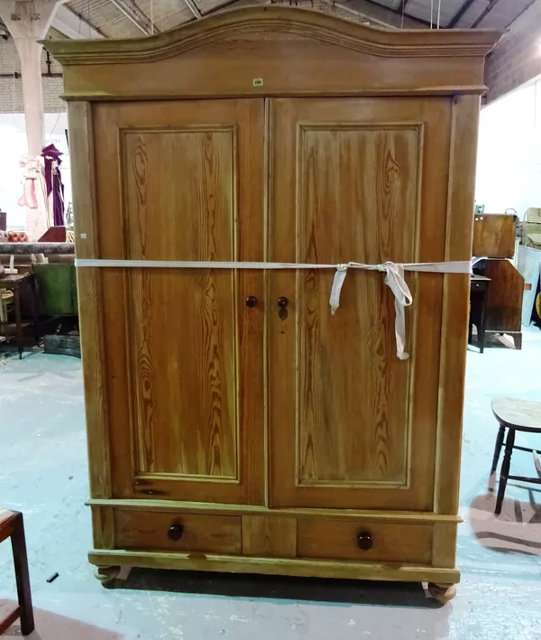 An early 20th century pine arch top double wardrobe two drawers to base, 151cm wide x 203cm high.  I8