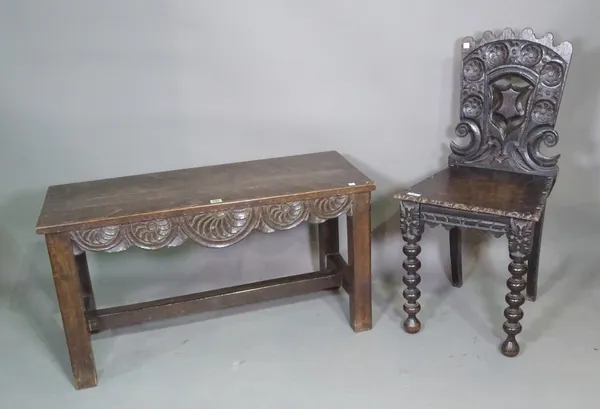 An 18th century and later oak hall bench with carved shell decoration on block supports, 95cm wide x 51cm high and a 17th century style carved oak hal