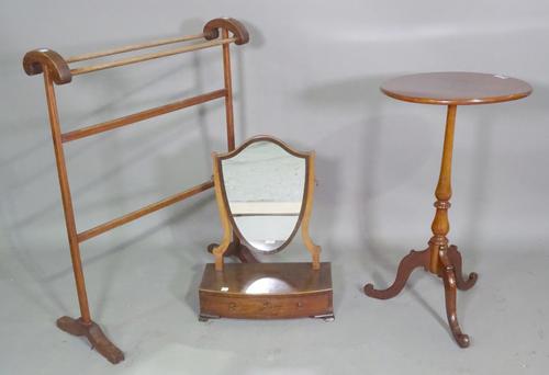 A George III mahogany shield back toilet mirror on bracket feet, 39cm wide x 50cm high., a 20th century stained pine towel rail 63cm wide x 82cm high