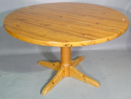 A 20th century pine circular dining table, 120cm wide x 73cm high and a set of four pine bar back dining chairs, (5).   G9