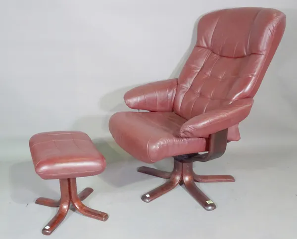 A 20th century burgundy leather reclining armchair and matching stool, (2).   D7