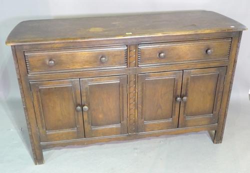 Ercol; a 20th century oak sideboard with rounded top over two drawers and four cupboard base on block supports, 145cm wide x 95cm high.   K8