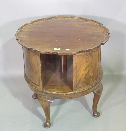 A 20th century mahogany revolving bookcase with pie crust top on tapering pad supports, 53cm wide x 52cm high. M6