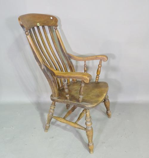 A Victorian ash and elm stick back open armchair on ring turned tapering supports.  J7