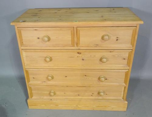 A 20th century pine chest of two short and three long drawers, 94cm wide x 86cm high, and a pine four tier open bookcase with single drawer, 45cm wide