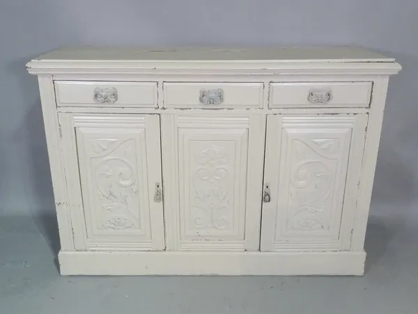 An Edwardian grey painted side cabinet with three drawers over three carved panel doors, 137cm wide x 97cm high.  BAY 2
