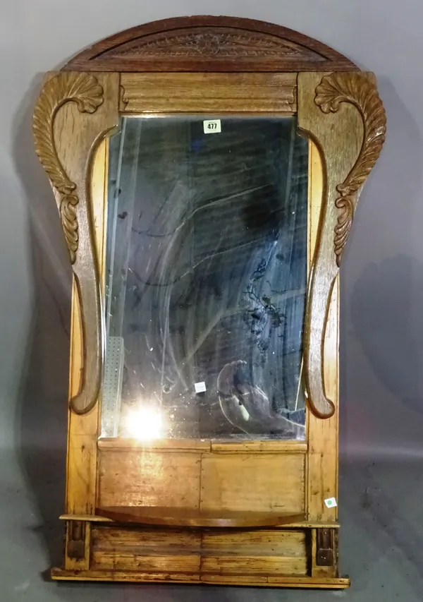 A Continental cartouche shaped wall mirror with shelf, 65cm wide x 110cm high.   G5
