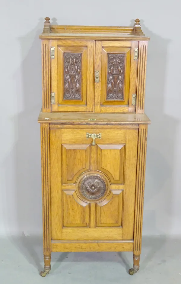 A 20th century oak coal purdonium with cabinet top with carved panel doors 48cm wide x 120cm high  J5