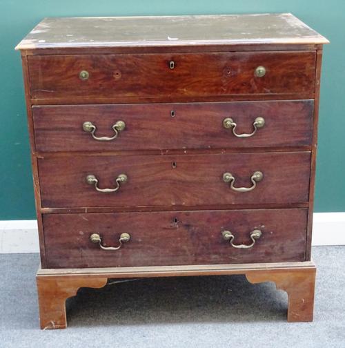 A George III mahogany chest with four long graduated drawers, on bracket feet, the top drawer with fitted interior, 95cm wide x 99cm high x 58cm deep.