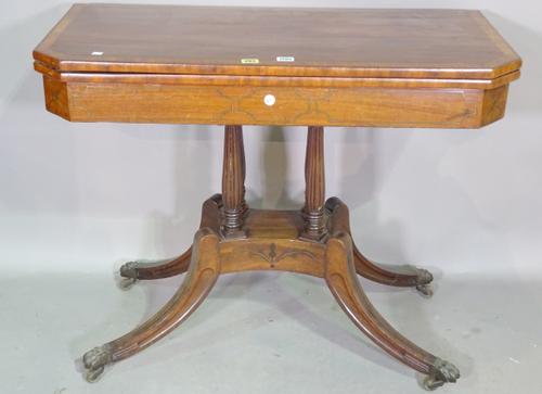 A Regency brass inlaid mahogany card table, the canted rectangular top on reeded baluster column and four downswept supports, 92cm wide x 75cm high x