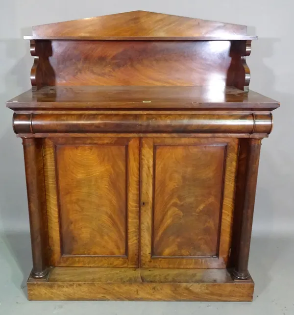 A William IV mahogany ledge back chiffonier with cushion frieze drawer over a pair of cupboards flanked by turned columns, 107cm wide x 131cm high x 5
